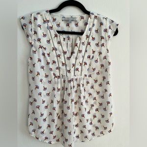 White cap sleeve top with colored flowers printed in size XS